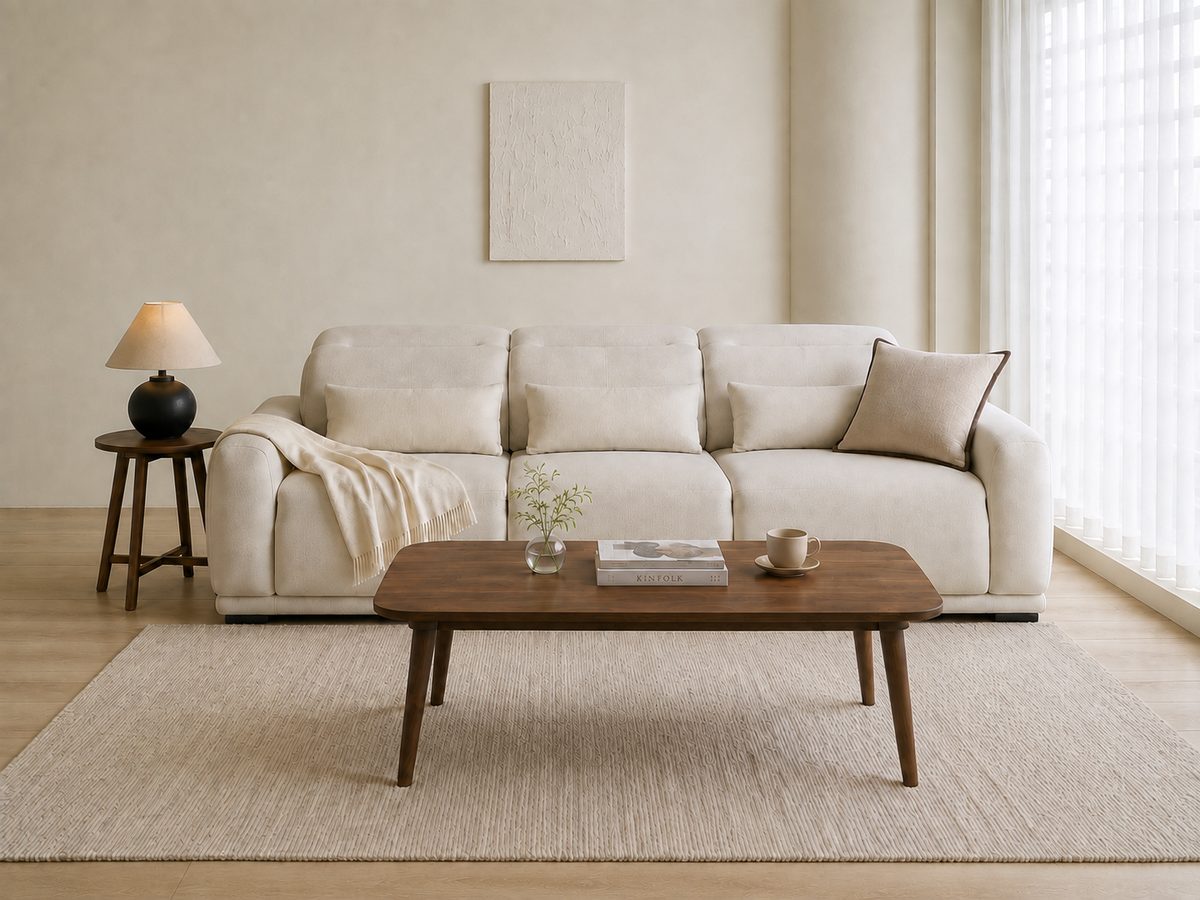 The same living room with the pale tile floor replaced by light oak plank flooring; the sofa, tables, rug and wall are unchanged
