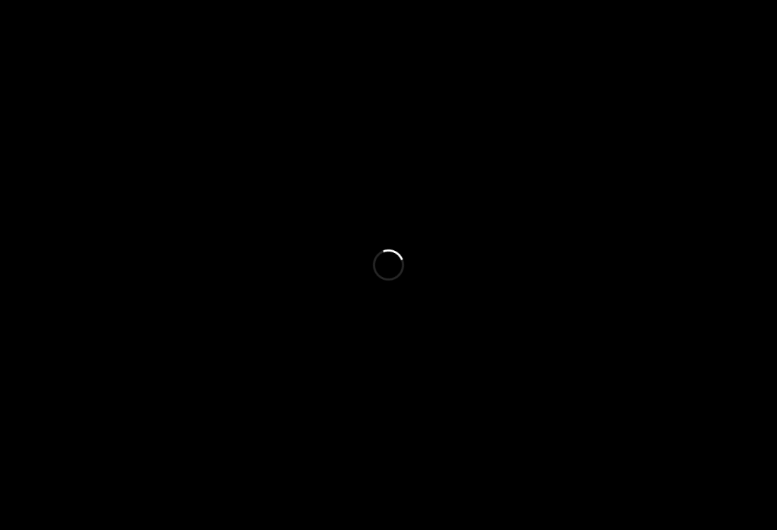 A black screen with a single loading spinner in the center
